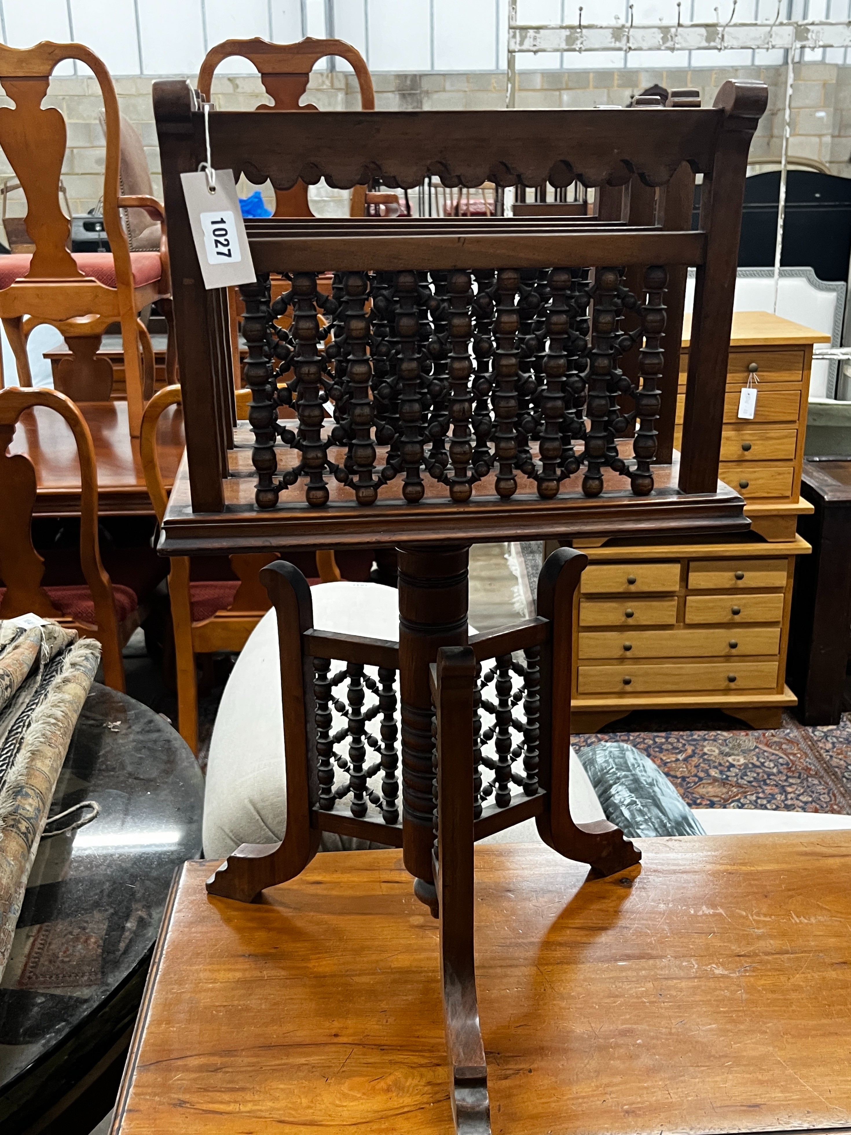 An early 20th century Moorish style walnut three division revolving newspaper stand, width 42cm, depth 34cm, height 76cm